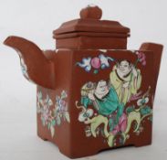 A handpainted Chinese Yi-Xing teapot of terracotta construction having handpainted foliate design