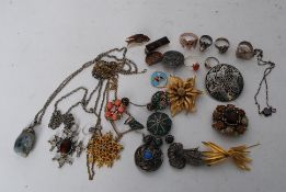 A collection of costume jewellery to include celtic brooch, decorative brooches, silver necklace,