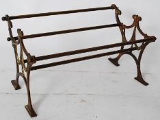 A Victorian brass book trough stand on the form of a park bench. Rococo scrolled bench ends having
