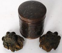 A pair of 20th century cast metal lion heads, along with an Indian metal trinket pot, made of