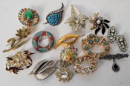 14 costume jewellery brooches and a pair of clip on earrings, including enamel painted, gold metal