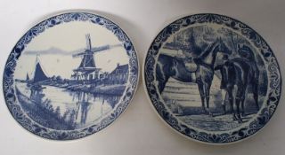 A pair of 20th century large Delft wall chargers decorated with classical dutch windmill and horse