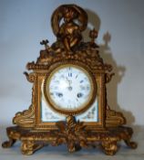 19th century French gilt metal 8 day mantel clock, The gilt metal body adorned with cherub over