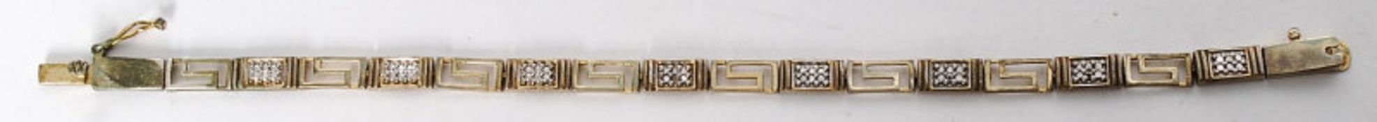 A white silver metal bracelet with greek key style decoration. Stamped 925 to clasp.