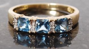 A 9ct three topaz and diamond channel set ring, Size R