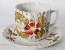 A hand painted 20th century Staffordshire china shaving cup and saucer with moustache guard