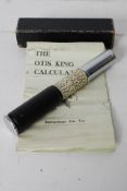A vintage Otis King manual calculator with algorithums and instruction manual