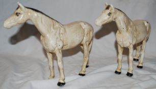 A pair of cast metal horse statues / bookends, each with hand painted finish and detail to eyes.
