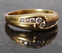 An 18ct gold diamond channel set ring, aprrox 20 Pts. Size L.
