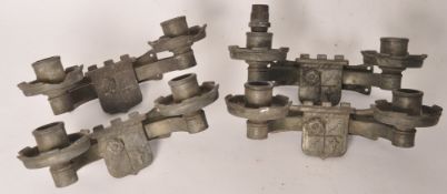 A set of 4 early 20th century wrought metal wall sconces of armorial style having central crests