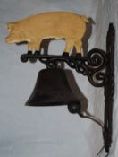 A vintage style cast metal doorbell in the form of a pig