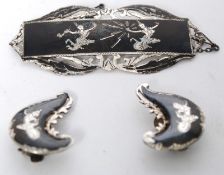 A white silver metal (stamped Sterling Silver) decorative ladies jewellery brooch and matching