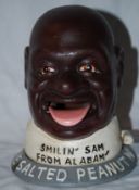 A 20th century cast metal advertising money box `Smilin` Sam From Alabam`` advertising peanuts.