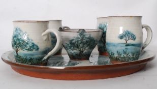A studio pottery tea service with tray. Comprising mugs, sugar bowl and tray. Decorative glazed