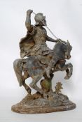 A vintage spelter statue of a horse riding warrior.