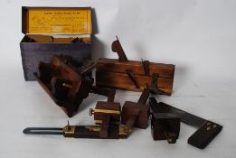 A collection of vintage wood working planes, including brass inlaid and others