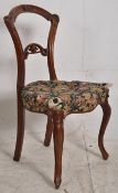 A Victorian mahogany kidney back bedroom chair. Raised on sabre supports having button back