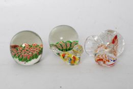 A collection of 5 glass paperweights, including two millefoiri examples