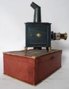 An early 20th century slide projector, by Bing. Being tin constructed with internal accessories and