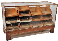 A 1930`s Art Deco oak and glass shop haberdashery display counter / cabinet. Raised on stepped deco