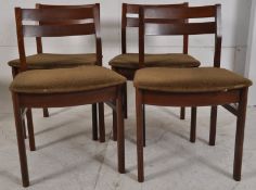A set of 4 Danish teak dining chairs. Raised on squared legs with overstuffed padded seats having