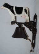 A 20th century cast metal bell in the form of a cow.