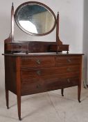 An Edwardian mahogany inlaid dressing table. Raised on square tapered supports with drawers and