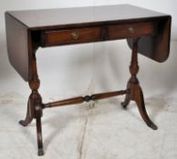 A Regency style mahogany writing desk table. Raised on splayed legs united by stretcher having twin