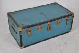A 20th century large blue canvas bound steamer trunk suitcase.