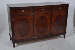A Regency style mahogany inlaid sideboard. Turned legs with cupboards beneath short drawers above