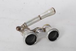 A pair of early 20th century mother of pearl opera glasses / binoculars complete with attached