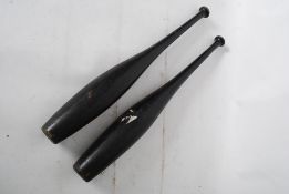 Pair of original ebonised Indian clubs 56 cms long