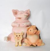 A pair of vintage butchers shop display advertising papier mache pigs. Together with a wooden pig