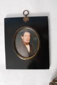 An antique 19th century oil painting miniature on ivory in an ebonised oval frame