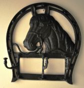 A cast metal coat / hat rack in the form of a horse, with folding hooks to the  front.