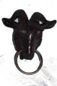 A cast iron goats head, with large heavyweight horns to top and ring pull to nose.
