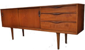A retro 1970`s Danish teak wood sideboard. Raised on turned legs supporting the low wide body