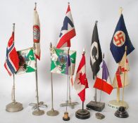 A collection of vintage diplomatic desktop flags on original stands