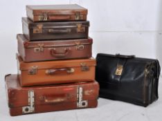 A collection of vintage suitcases to include various sizes, some graduating in size along with an