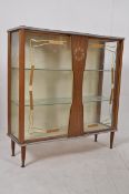 A 1970`s formica display cabinet having faux clock centre, raised on turned supports.