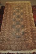 A small belgian kelim style rug having geometric design with tassled ends