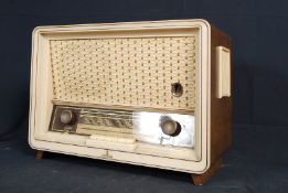 A 1950`s Siemans walnut and plastic valve radio of decorative form