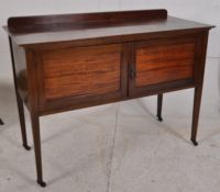 An Edwardian mahogany inlaid hall cupboard / cabinet. Raised on squared legs having castors to