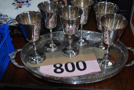 A set of six plated wine goblets along with a silverplate fretwork tray.
