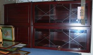 A pair of mahogany effect tall corner cabinets having glass display cabinets atop over cupboards