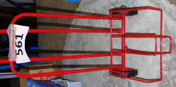 A new set of red painted cast metal sack / carry trucks with wire holding tray.