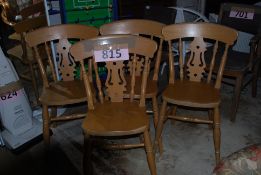 Four pine spindle backed dining chairs.