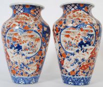 A pair of late 18th / early 19th century Imari oriental Japanese vases. Being hand painted in red