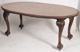 A late Victorian wind out mahogany extending dining table. The large cabriole legs with ball and