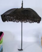 An Edwardian lace work ladies sun parasol having lined underside and laced borders. All on ebonised